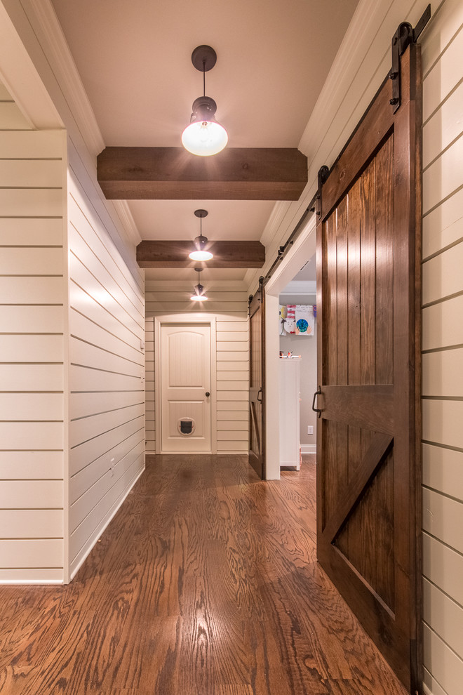 Photo of a small country look-out basement in Atlanta with white walls, dark hardwood floors, no fireplace and brown floor.