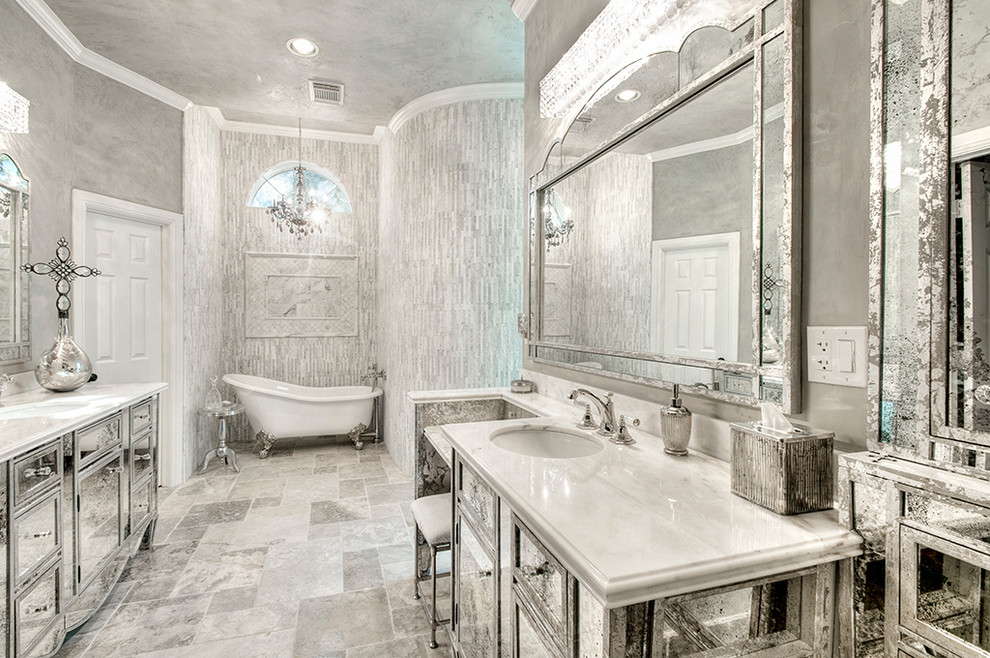 Photo of a large transitional master bathroom in Houston with glass-front cabinets, marble benchtops, grey walls, marble floors, a claw-foot tub, gray tile and an undermount sink.