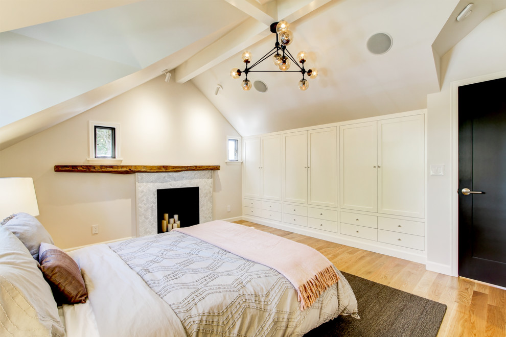Mid-sized transitional master bedroom in Seattle with white walls, medium hardwood floors, a standard fireplace and a tile fireplace surround.