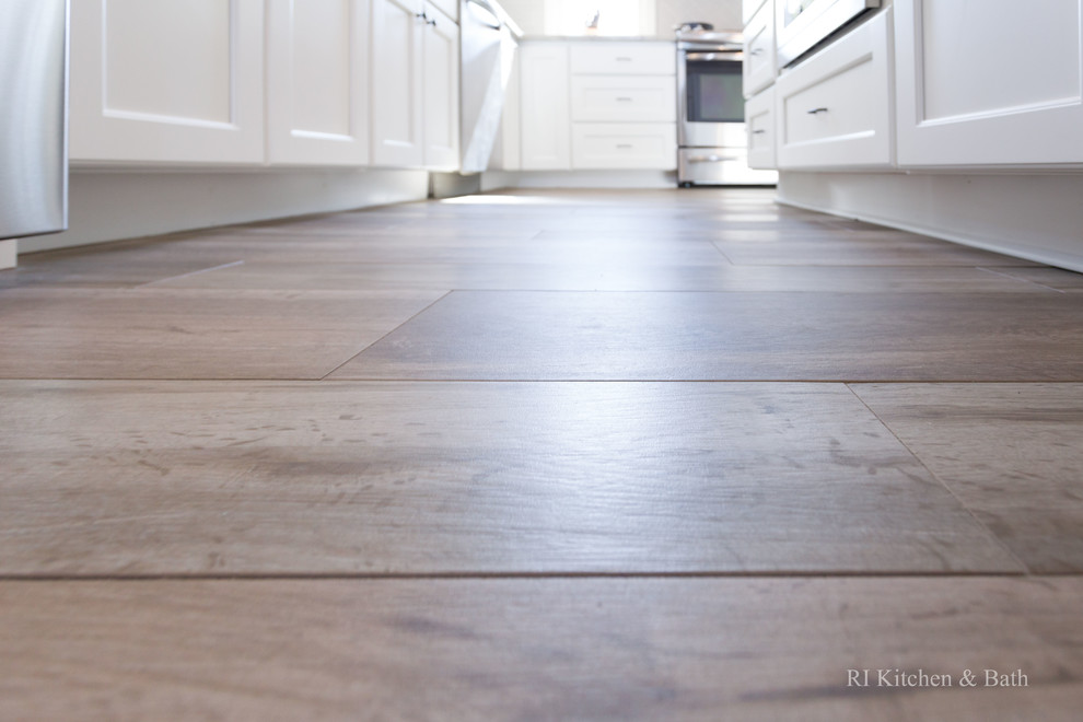 Example of a large transitional l-shaped porcelain tile eat-in kitchen design in Providence with an undermount sink, recessed-panel cabinets, white cabinets, granite countertops, gray backsplash, ceramic backsplash, stainless steel appliances, green walls and an island