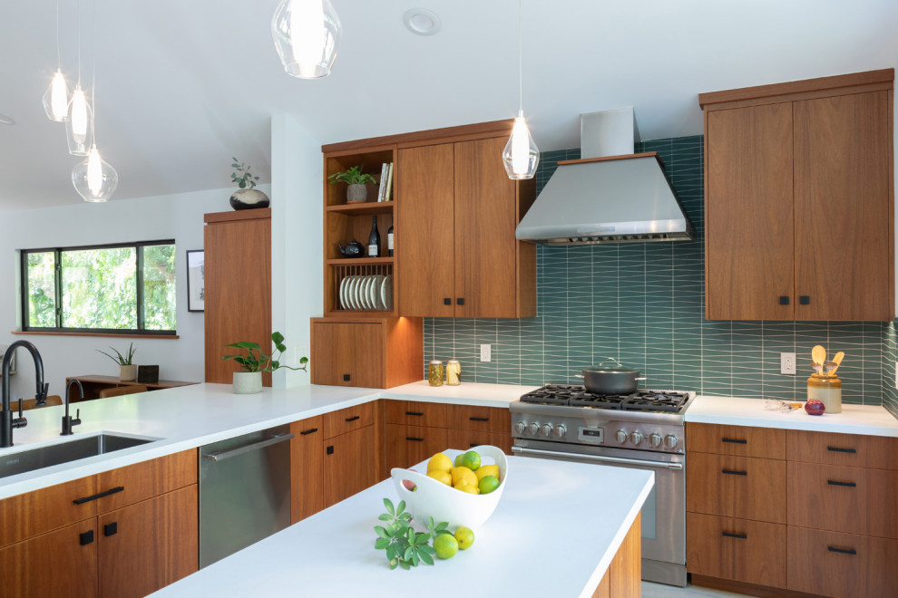 Design ideas for a modern eat-in kitchen in Los Angeles with an undermount sink, flat-panel cabinets, medium wood cabinets, quartz benchtops, blue splashback, glass tile splashback, stainless steel appliances, light hardwood floors, with island, white benchtop and vaulted.