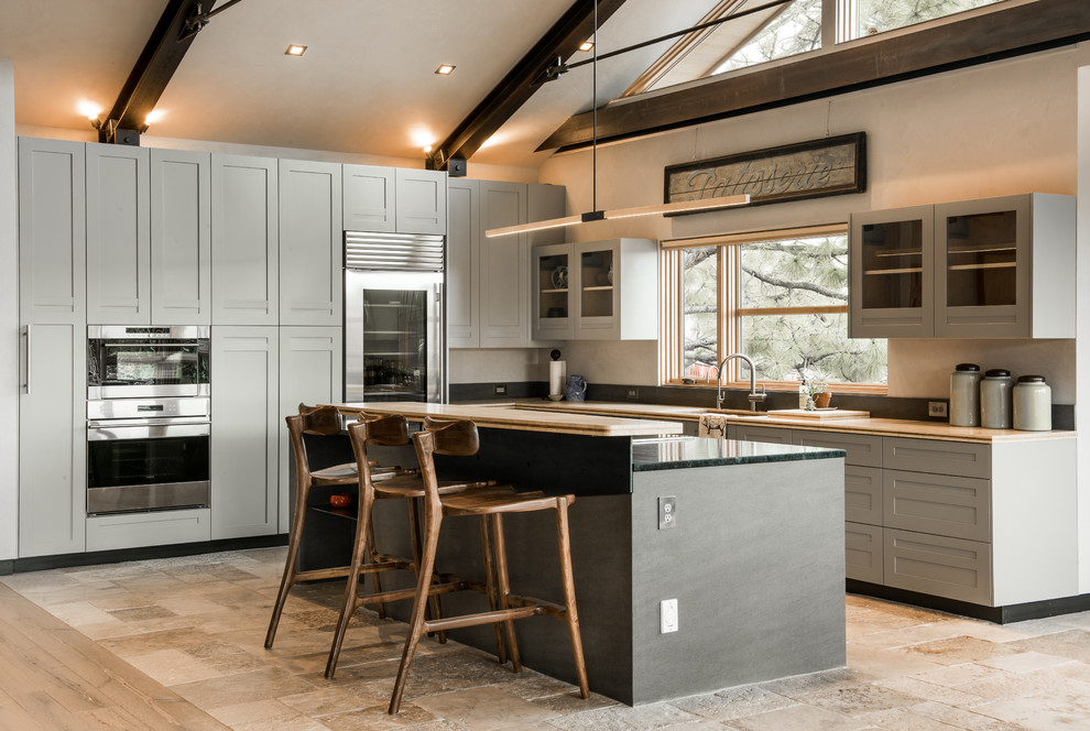 Design ideas for a mid-sized contemporary l-shaped eat-in kitchen in Other with an undermount sink, shaker cabinets, grey cabinets, granite benchtops, stainless steel appliances, concrete floors, with island and beige floor.