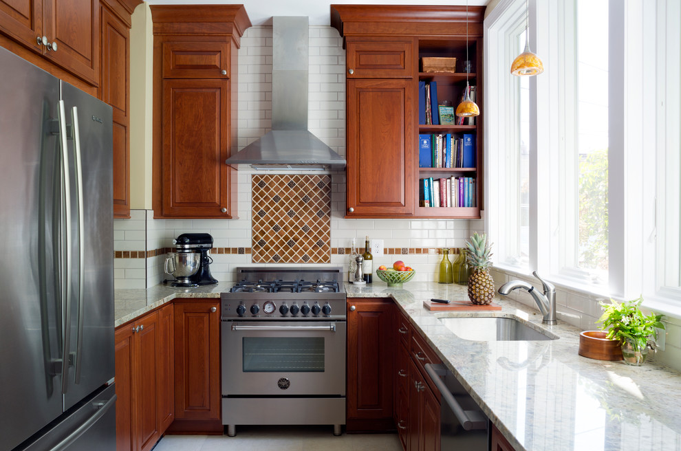 Design ideas for a small transitional u-shaped separate kitchen in DC Metro with an undermount sink, raised-panel cabinets, dark wood cabinets, brown splashback, subway tile splashback, stainless steel appliances and no island.