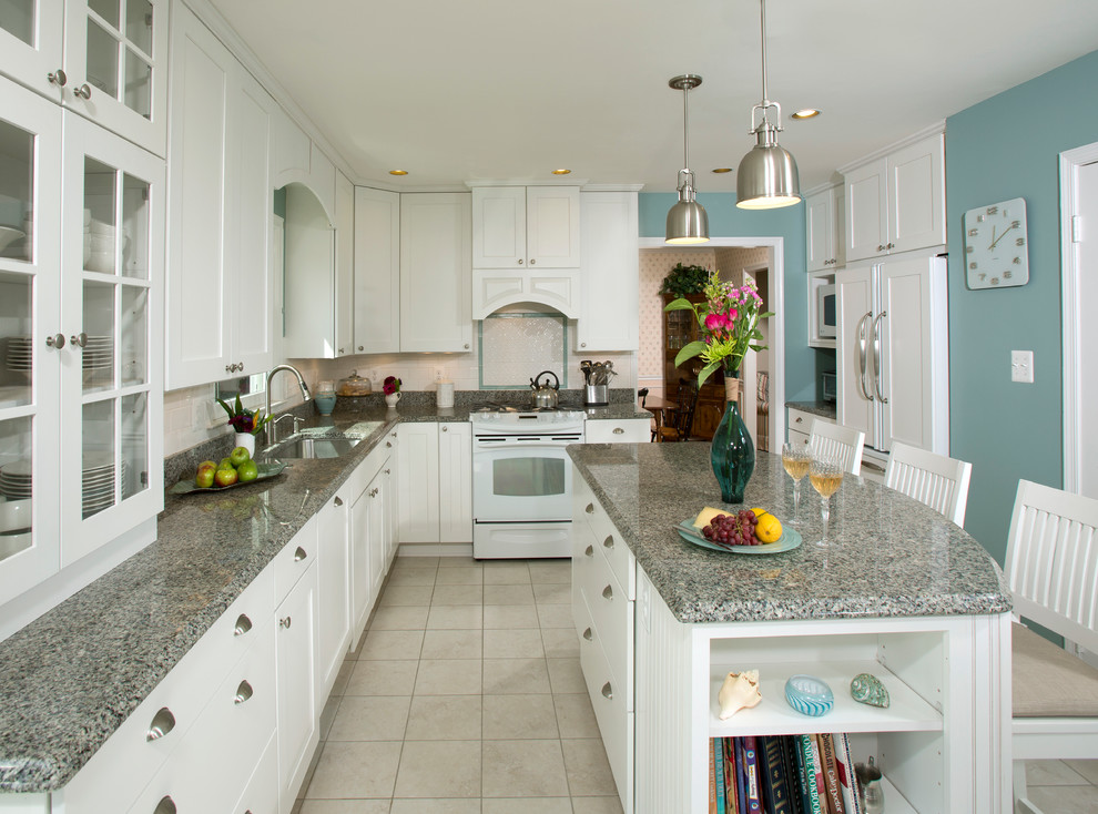 Design ideas for a traditional l-shaped eat-in kitchen in DC Metro with an undermount sink, shaker cabinets, white cabinets, granite benchtops, white splashback, white appliances, ceramic floors and with island.