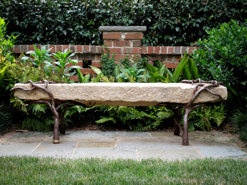 Inspiration for a mid-sized traditional backyard garden in Other with natural stone pavers.