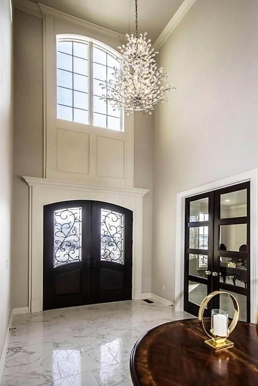 Example of a large transitional marble floor and white floor foyer design in Columbus with gray walls and a dark wood front door