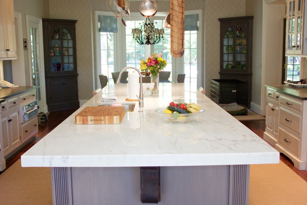 Example of a large transitional dark wood floor eat-in kitchen design in DC Metro with marble countertops, an island, white cabinets, white backsplash and stainless steel appliances