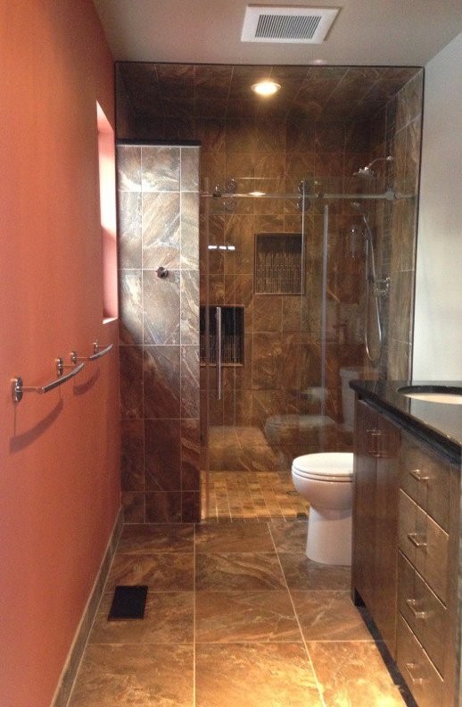 This is an example of a small contemporary master bathroom in Newark with an undermount sink, flat-panel cabinets, dark wood cabinets, engineered quartz benchtops, an alcove shower, brown tile, porcelain tile, orange walls and porcelain floors.