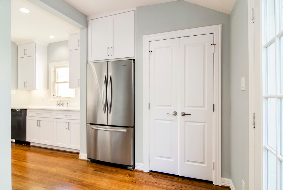 Eat-in kitchen - transitional galley eat-in kitchen idea in Dallas with an undermount sink, shaker cabinets, white cabinets, marble countertops, white backsplash, subway tile backsplash and stainless steel appliances