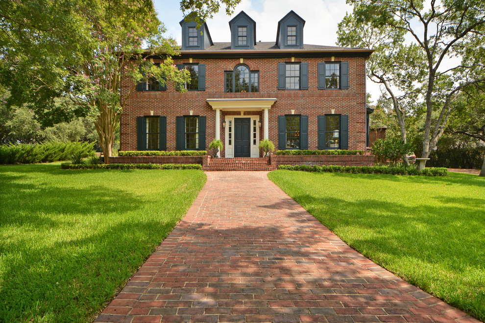 Photo of a large traditional three-storey brick exterior in Austin with a hip roof.
