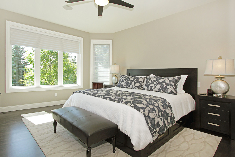 Inspiration for a mid-sized transitional master bedroom in Calgary with grey walls, dark hardwood floors and black floor.