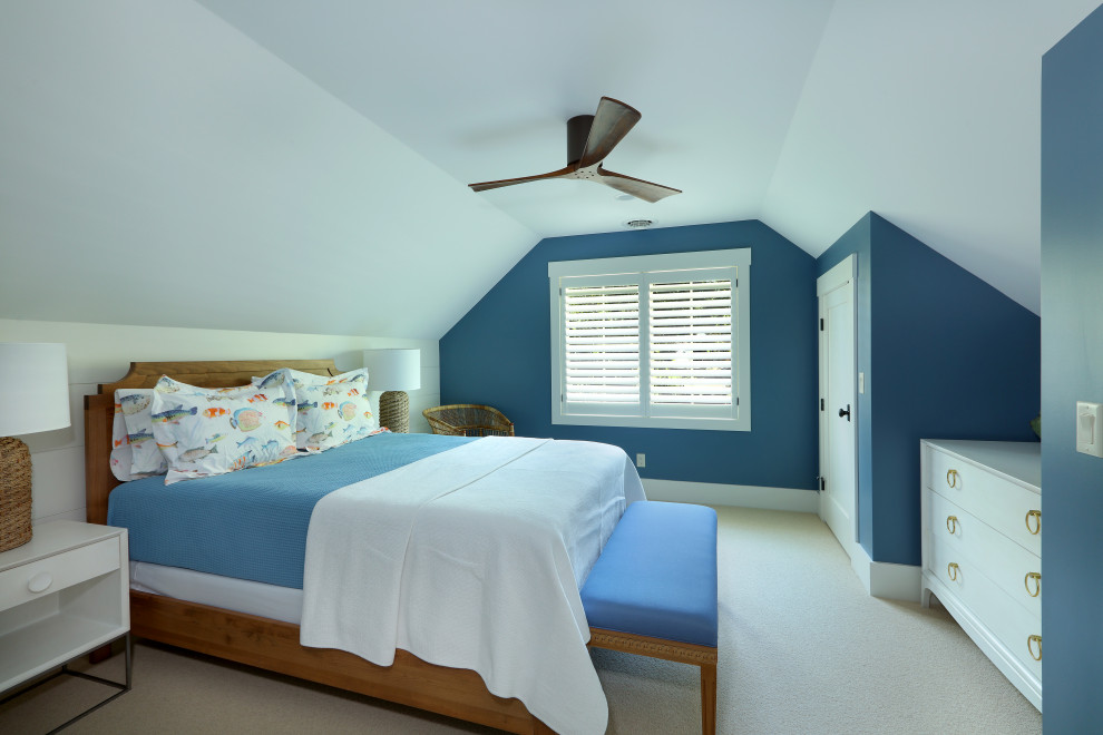 Design ideas for a mid-sized beach style guest bedroom in Grand Rapids with beige walls, porcelain floors, white floor, wallpaper and no fireplace.