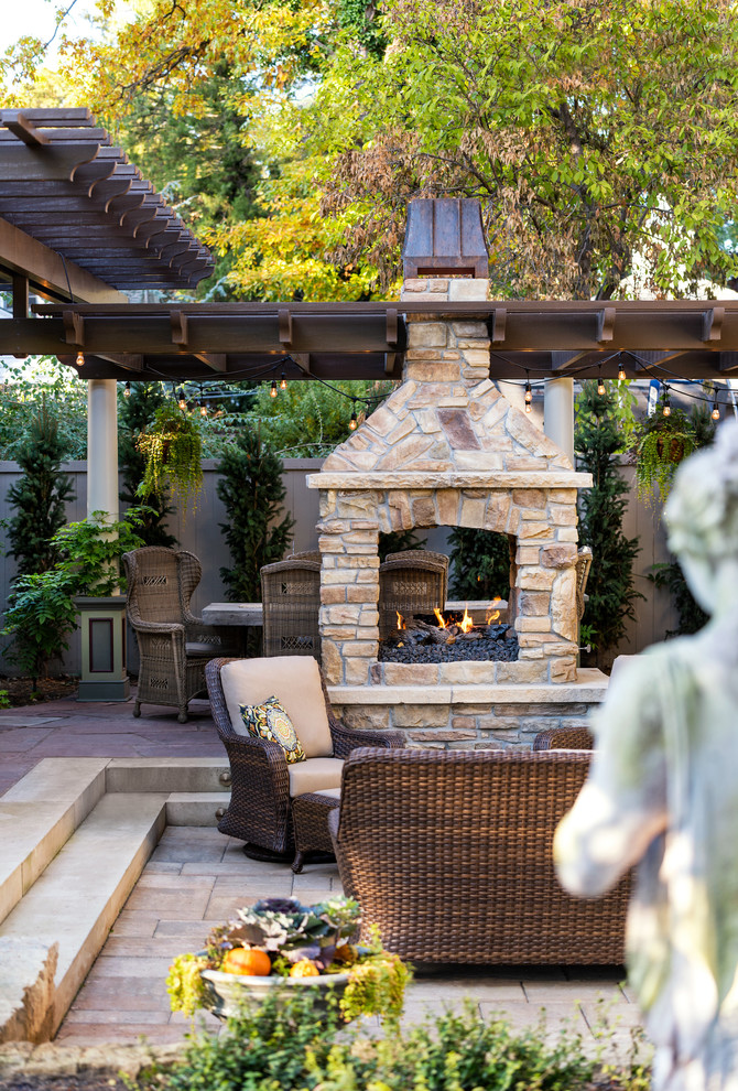 Photo of a mid-sized traditional backyard patio in Boise with a fire feature, concrete pavers and a pergola.