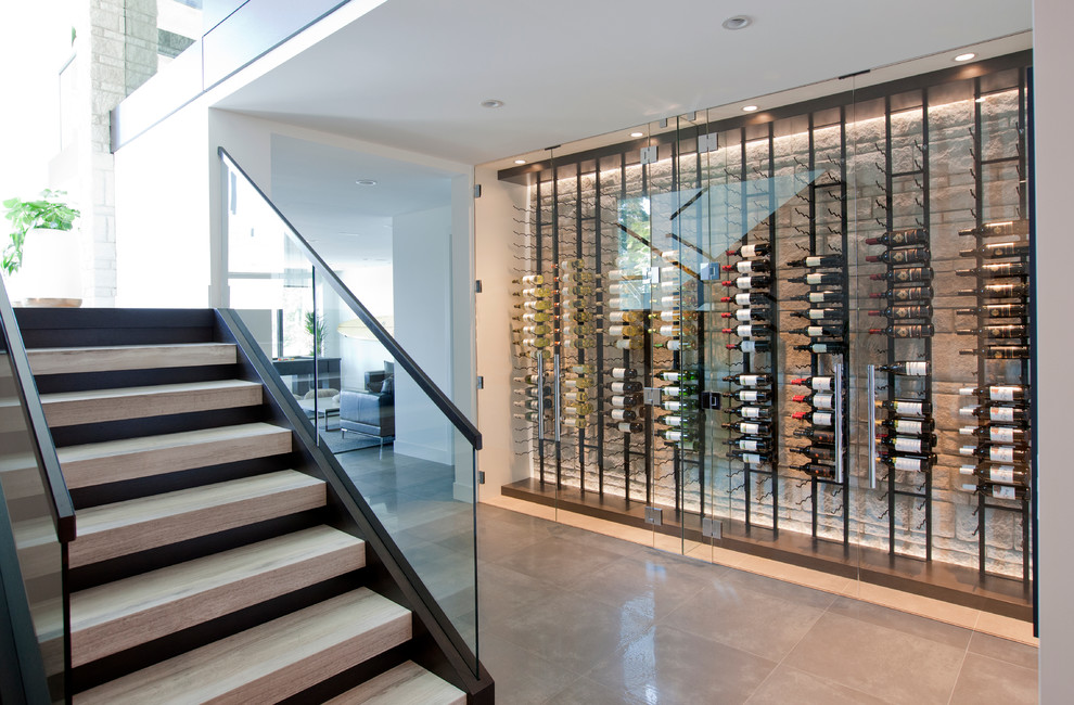 Inspiration for a small contemporary wine cellar in Vancouver with porcelain floors and display racks.