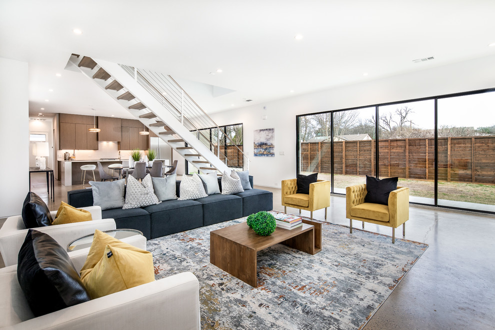 Photo of a large modern formal open concept living room in Dallas with white walls, concrete floors and grey floor.