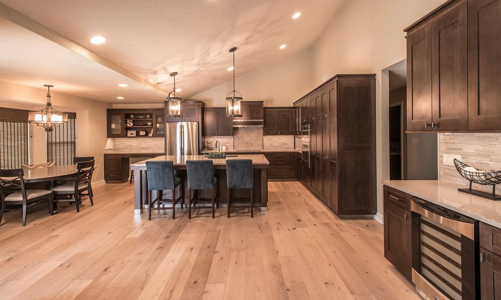 Large transitional l-shaped light wood floor eat-in kitchen photo in Phoenix with an undermount sink, shaker cabinets, dark wood cabinets, quartz countertops, beige backsplash, matchstick tile backsplash, stainless steel appliances and an island