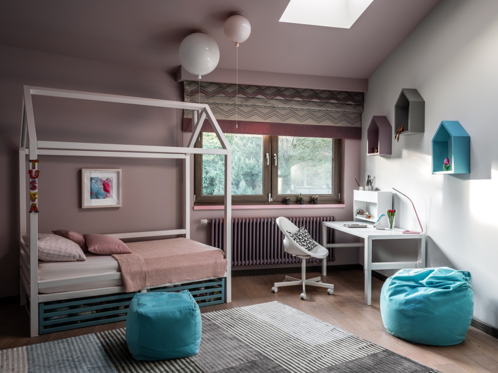 This is an example of a large contemporary children’s room for girls in Moscow with light hardwood flooring, beige floors and pink walls.
