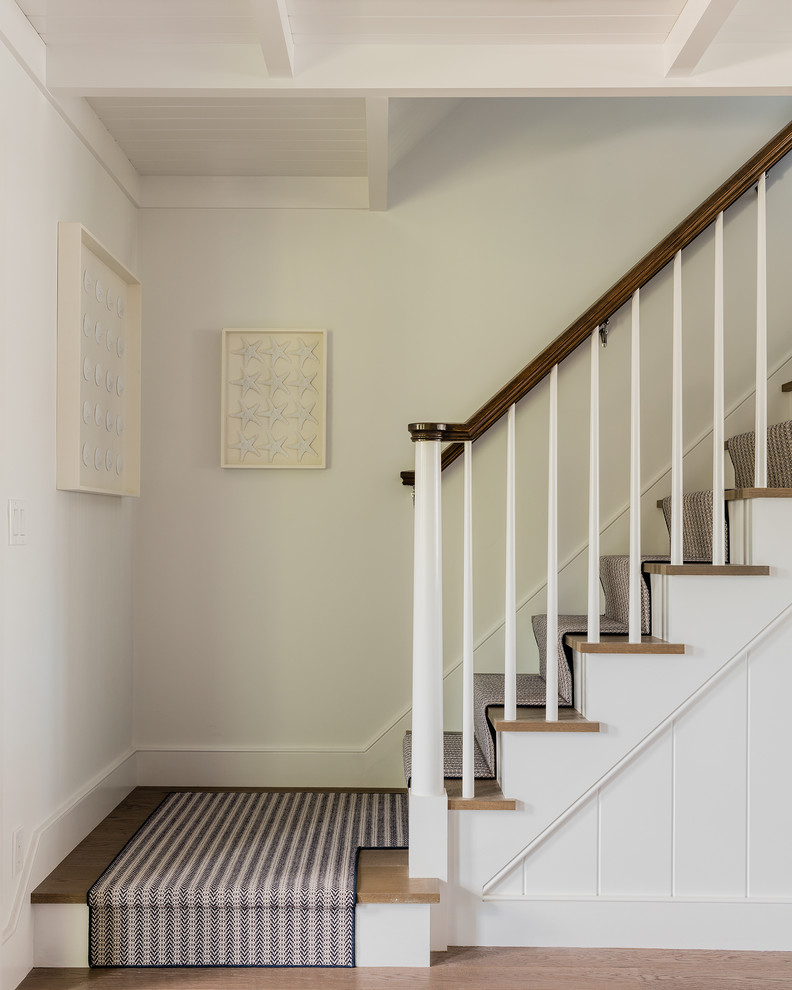 Mid-sized beach style wood l-shaped staircase in Boston with painted wood risers.