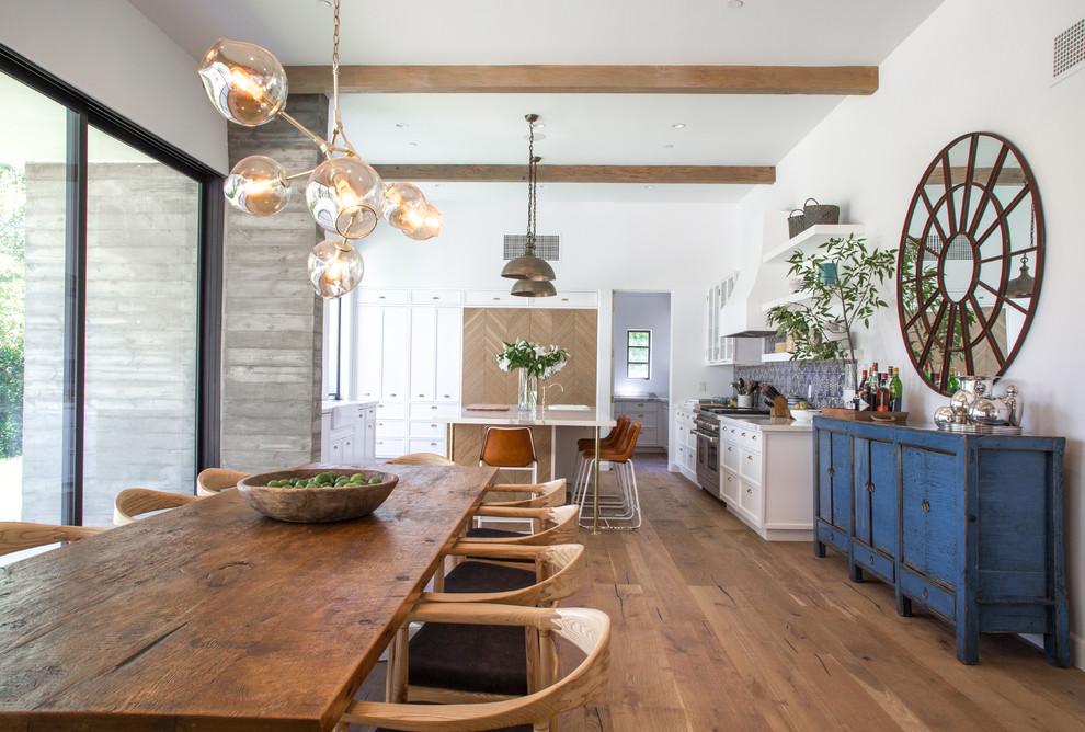 Inspiration for a large transitional open plan dining in Los Angeles with white walls, dark hardwood floors and brown floor.