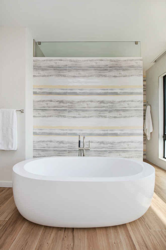 Design ideas for a mid-sized modern master bathroom in Tampa with flat-panel cabinets, grey cabinets, a freestanding tub, a curbless shower, a bidet, yellow tile, porcelain tile, white walls, porcelain floors, an undermount sink, engineered quartz benchtops, brown floor and white benchtops.