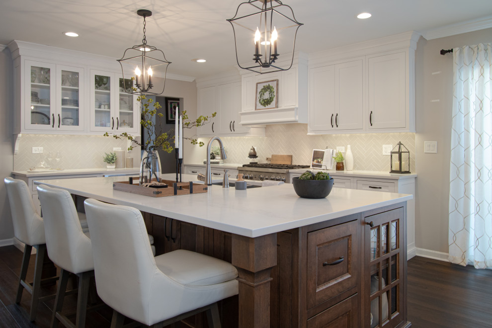 Transitional kitchen photo in Chicago with white cabinets, quartz countertops, ceramic backsplash, stainless steel appliances, an island and white countertops