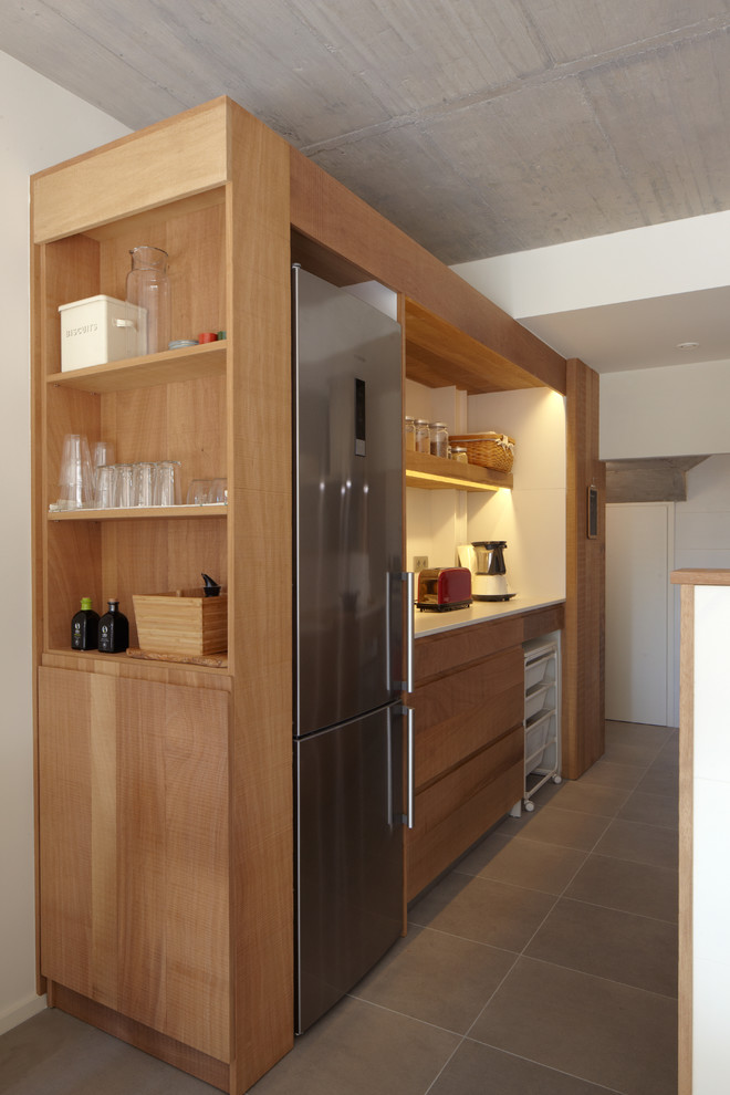 Mid-sized scandinavian galley open plan kitchen in Barcelona with flat-panel cabinets, medium wood cabinets, stainless steel appliances, ceramic floors and no island.