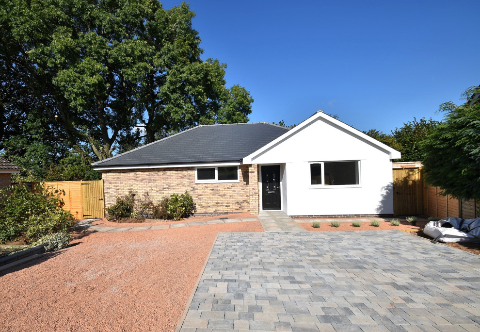 Design ideas for a small and multi-coloured traditional bungalow detached house in Gloucestershire with mixed cladding, a pitched roof and a tiled roof.