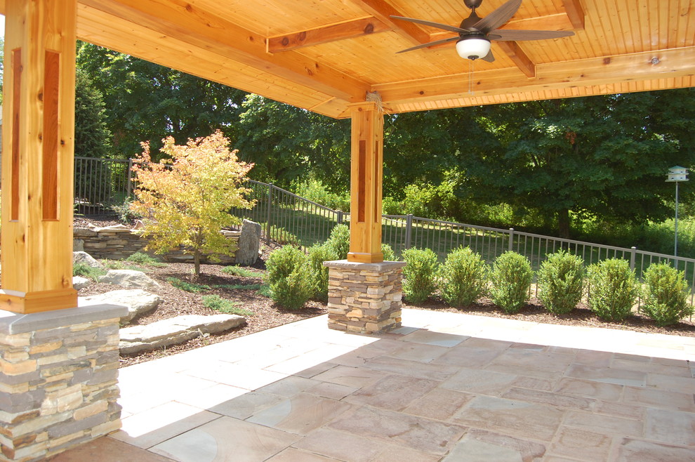 Mid-sized arts and crafts backyard patio in Philadelphia with natural stone pavers and a gazebo/cabana.