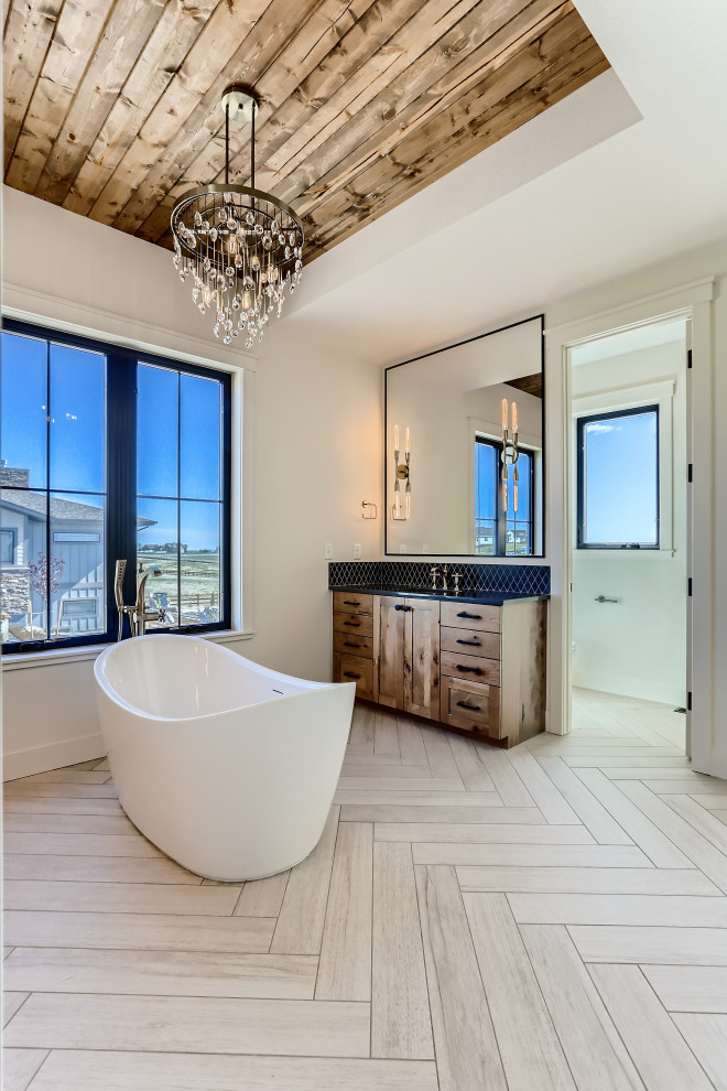 This is an example of a large country master bathroom in Denver with shaker cabinets, dark wood cabinets, a freestanding tub, an alcove shower, a one-piece toilet, white tile, porcelain tile, white walls, ceramic floors, quartzite benchtops, beige floor, an open shower, black benchtops, a double vanity, a built-in vanity, wood and an undermount sink.
