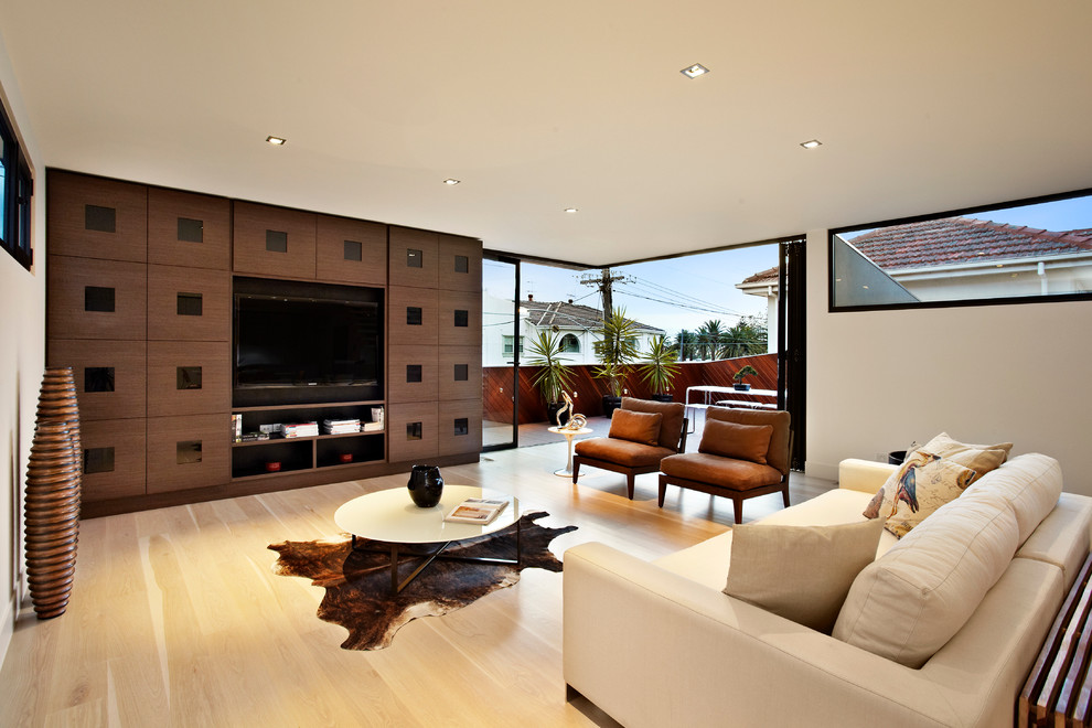 This is an example of a contemporary living room in Melbourne with a built-in media wall.