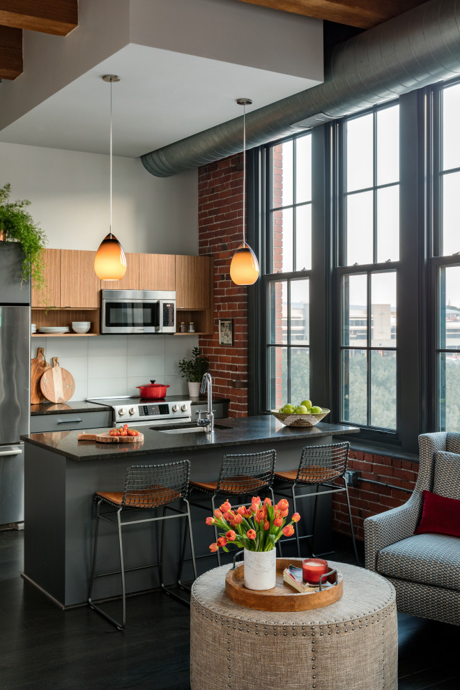 Inspiration for a mid-sized industrial single-wall separate kitchen in Boston with an undermount sink, flat-panel cabinets, medium wood cabinets, granite benchtops, stainless steel appliances, dark hardwood floors and with island.