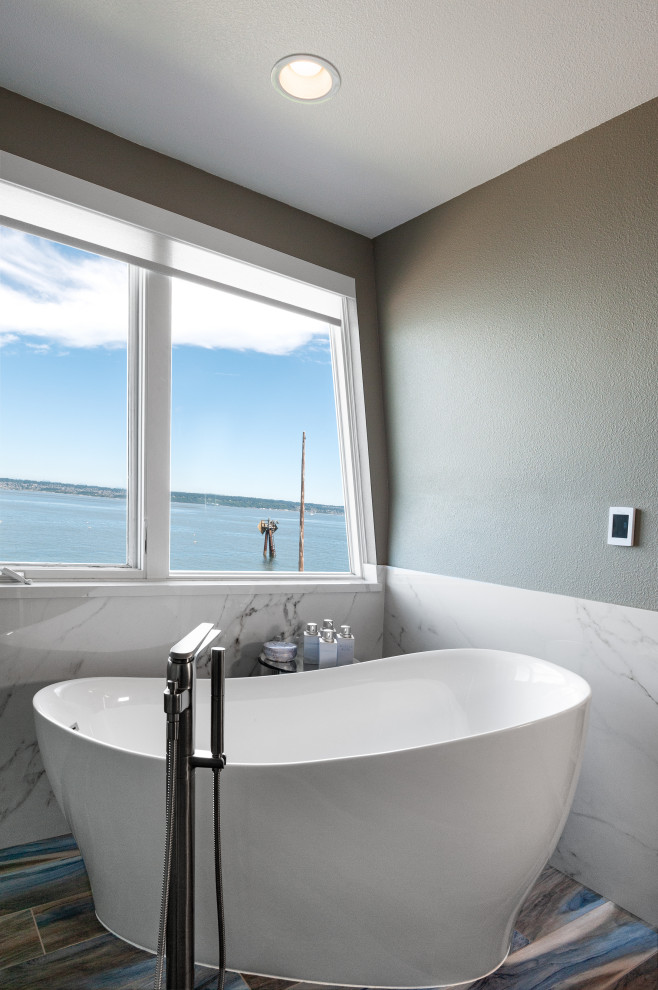 Inspiration for a large contemporary master bathroom in Seattle with flat-panel cabinets, white cabinets, a freestanding tub, a curbless shower, a two-piece toilet, white tile, stone slab, grey walls, wood-look tile, a vessel sink, engineered quartz benchtops, blue floor, a hinged shower door, beige benchtops, a shower seat, a double vanity and a built-in vanity.