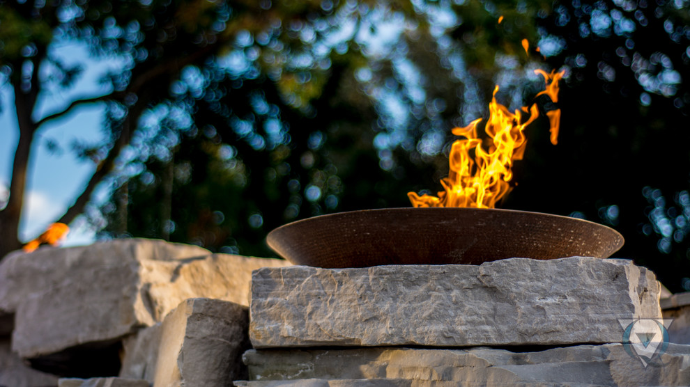 Large mountain style backyard stone and rectangular natural pool fountain photo in Chicago