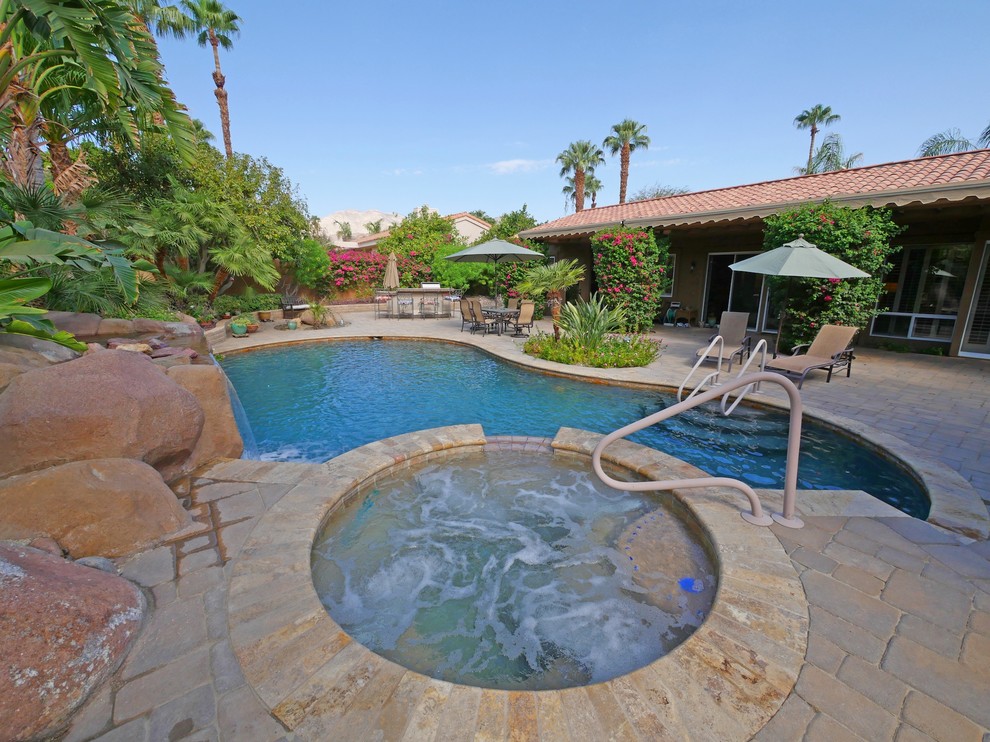 Mediterranean backyard custom-shaped pool in Los Angeles.