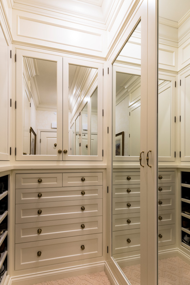 Inspiration for a large traditional gender-neutral walk-in wardrobe in Cincinnati with beaded inset cabinets, white cabinets, carpet and beige floor.