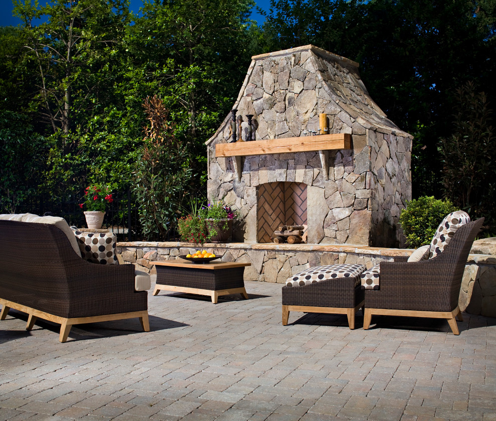 Photo of a traditional patio in Charlotte with a fire feature and concrete pavers.