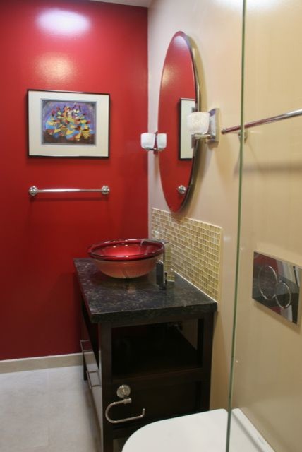 This is an example of a small modern master bathroom in San Francisco with furniture-like cabinets, dark wood cabinets, an alcove shower, a wall-mount toilet, yellow tile, glass tile, red walls, porcelain floors, a vessel sink and engineered quartz benchtops.