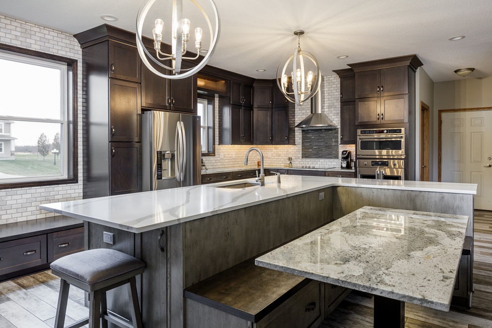 Mid-sized transitional l-shaped ceramic tile and multicolored floor eat-in kitchen photo with an undermount sink, shaker cabinets, medium tone wood cabinets, quartz countertops, white backsplash, marble backsplash, stainless steel appliances, an island and white countertops
