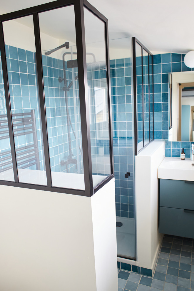 Photo of a small contemporary master bathroom in Paris with blue cabinets, a corner shower, a wall-mount toilet, blue tile, cement tile, blue walls, cement tiles, a console sink, green floor, a hinged shower door, white benchtops, a single vanity and a built-in vanity.