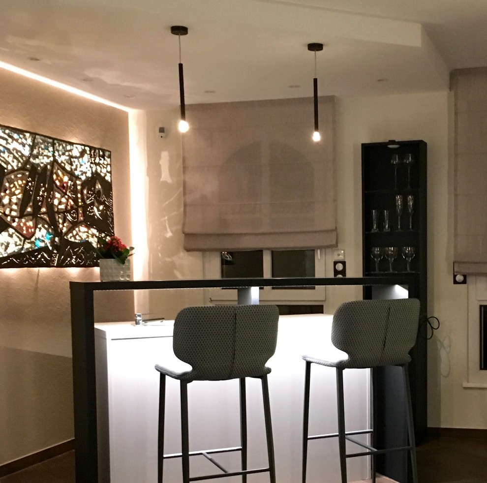 This is an example of a mid-sized contemporary single-wall seated home bar in Strasbourg with an undermount sink, beaded inset cabinets, beige cabinets, laminate benchtops, ceramic floors, brown floor and beige benchtop.