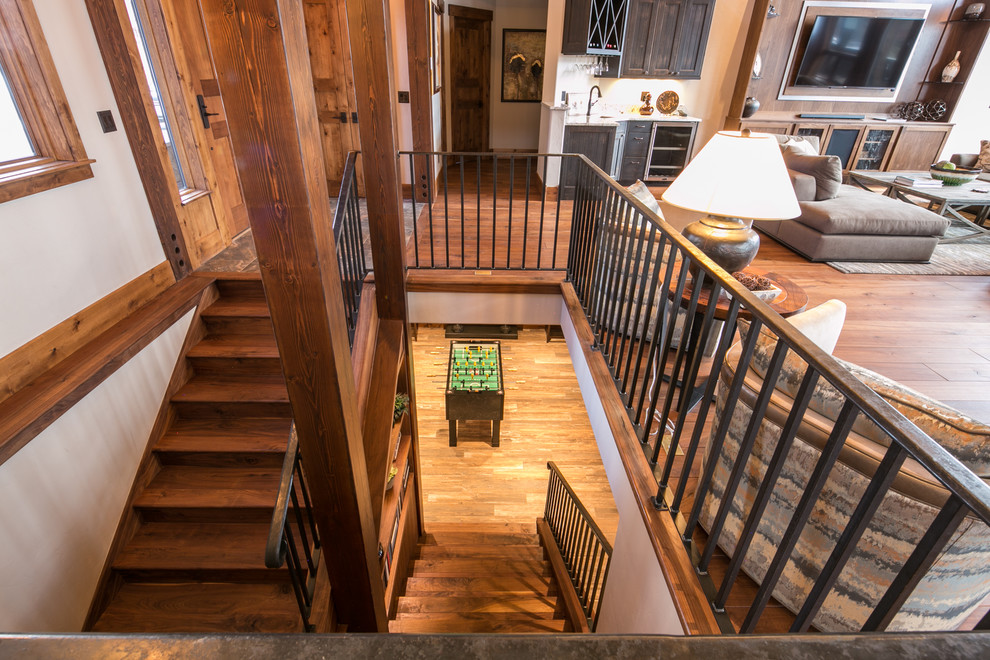 This is an example of a mid-sized country wood u-shaped staircase in Denver with wood risers.