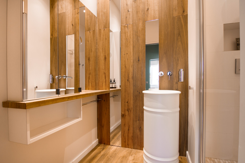 Photo of a medium sized modern shower room bathroom in Other with white cabinets, white tiles, ceramic tiles, white walls, medium hardwood flooring, a pedestal sink, wooden worktops, brown floors, white worktops, a single sink, a floating vanity unit and wood walls.