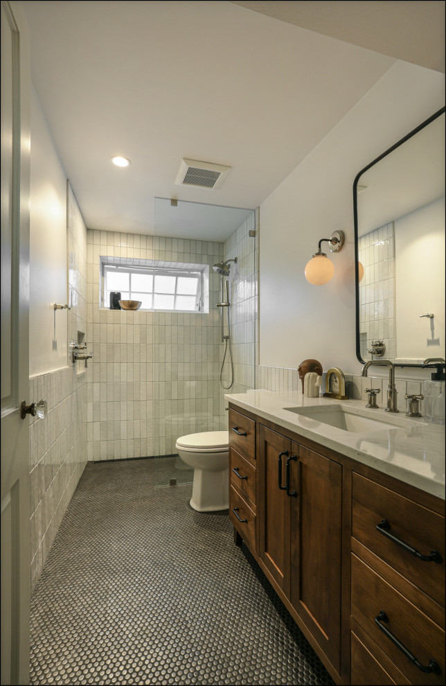 This is an example of a mid-sized arts and crafts kids bathroom in Portland with shaker cabinets, dark wood cabinets, a curbless shower, white tile, porcelain tile, white walls, porcelain floors, an undermount sink, engineered quartz benchtops, black floor, an open shower, white benchtops, a niche, a single vanity and a built-in vanity.