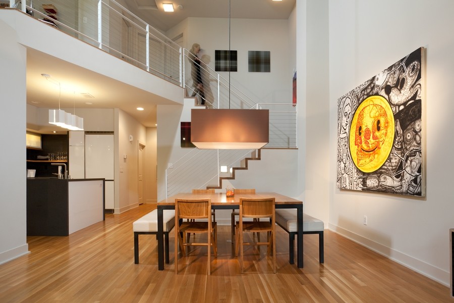 This is an example of an expansive modern kitchen/dining combo in Sacramento with white walls and light hardwood floors.
