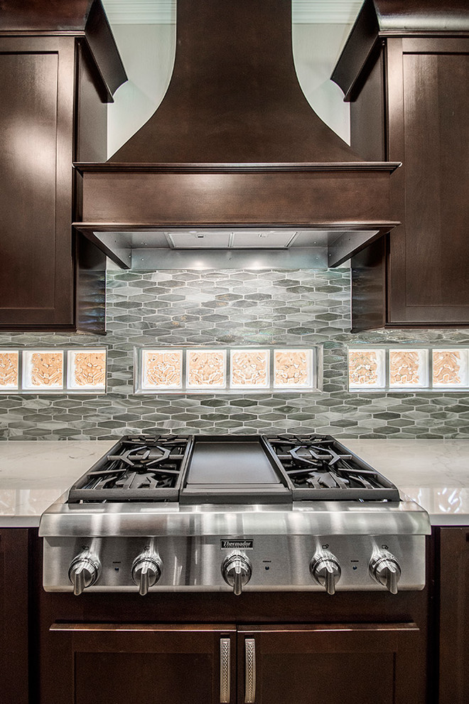 Mid-sized transitional l-shaped medium tone wood floor and brown floor open concept kitchen photo in DC Metro with an undermount sink, recessed-panel cabinets, dark wood cabinets, granite countertops, beige backsplash, ceramic backsplash, stainless steel appliances, an island and beige countertops