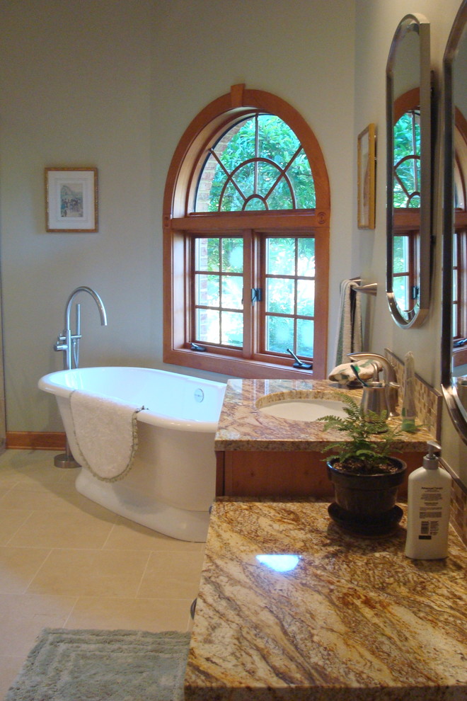 Photo of a large transitional master bathroom in Other with flat-panel cabinets, a freestanding tub, a corner shower, a wall-mount toilet, multi-coloured tile, pebble tile, grey walls, ceramic floors, an undermount sink and granite benchtops.