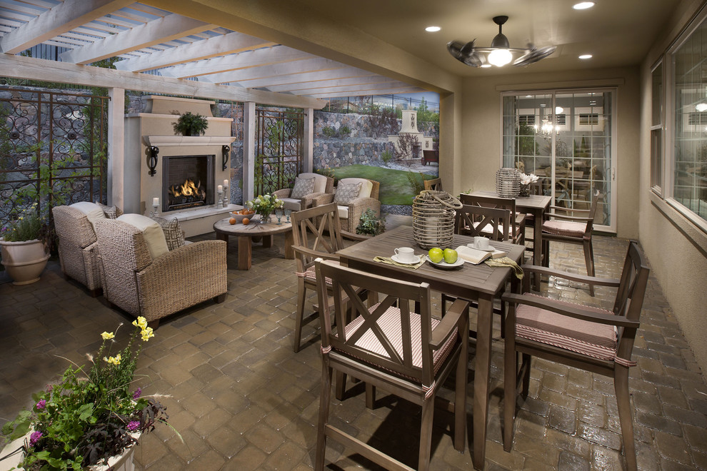 This is an example of a mediterranean verandah in Denver with a fire feature and a pergola.