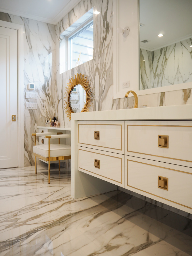 Photo of a large transitional master bathroom in New York with flat-panel cabinets, white cabinets, an undermount tub, an open shower, a one-piece toilet, white tile, marble, white walls, marble floors, an undermount sink, engineered quartz benchtops, white floor, a hinged shower door, white benchtops, a shower seat, a double vanity and a built-in vanity.