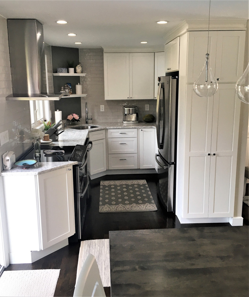 Inspiration for a small transitional u-shaped dark wood floor and brown floor eat-in kitchen remodel in Boston with an undermount sink, shaker cabinets, white cabinets, quartz countertops, gray backsplash, subway tile backsplash, stainless steel appliances and gray countertops
