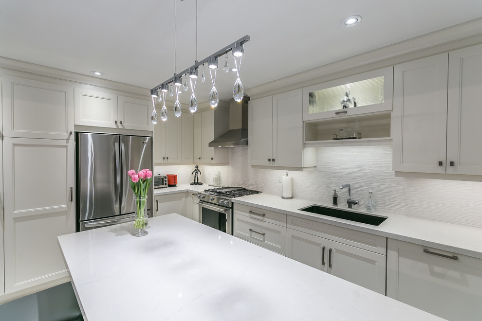 Eat-in kitchen - mid-sized transitional l-shaped porcelain tile eat-in kitchen idea in Toronto with a drop-in sink, recessed-panel cabinets, white cabinets, quartz countertops, stainless steel appliances and an island